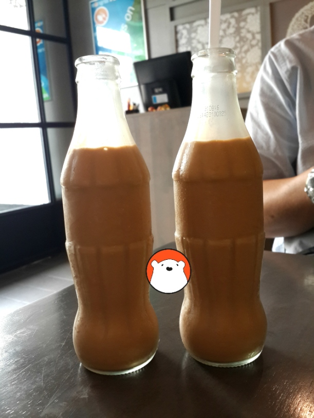 The milk tea, served in recycled small Coke bottles, is Bt39 each.  