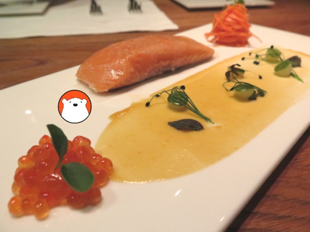 An appetiser of Tasmanian Ocean Trout Confit (Bt370) with pickled vegetables and orange miso coulis.